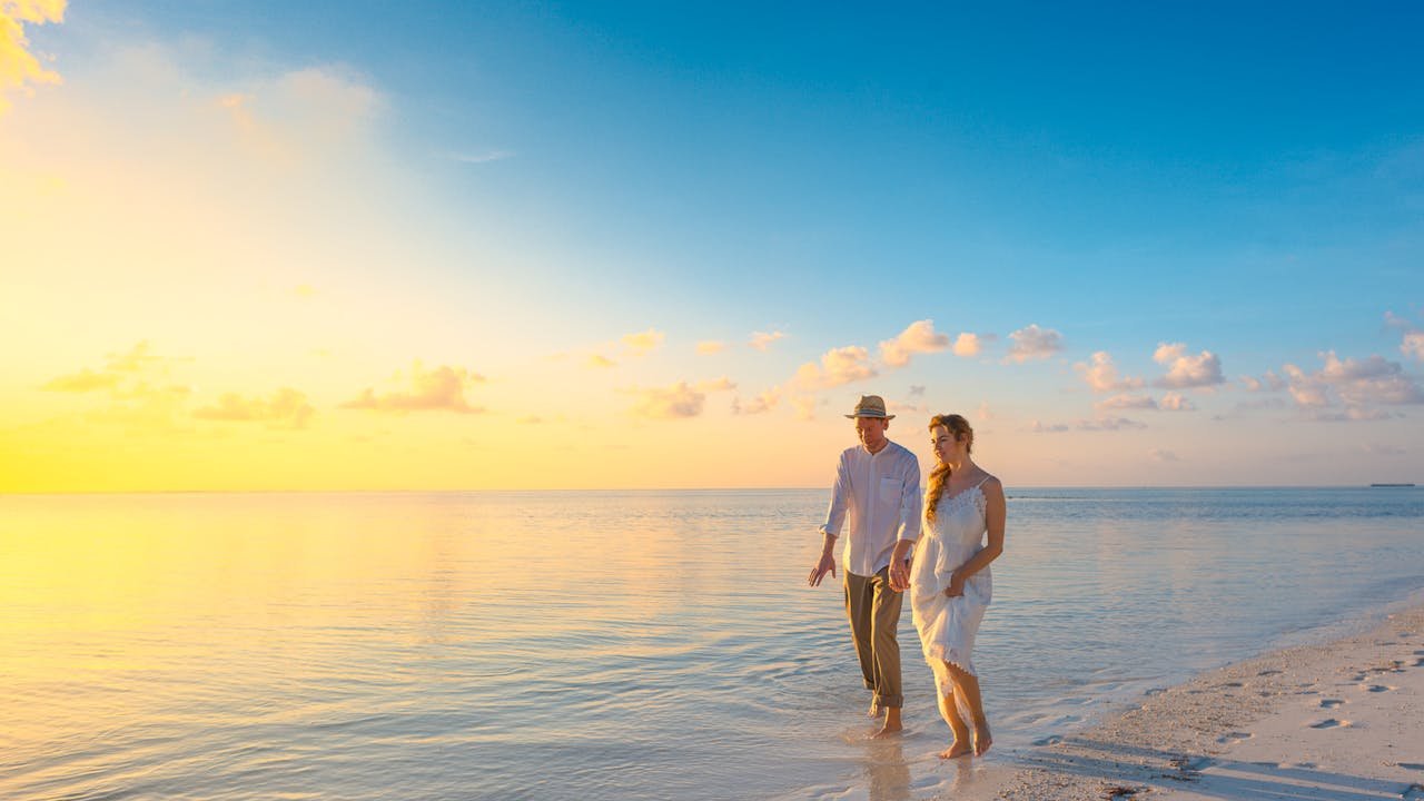 A couple walking along the beach