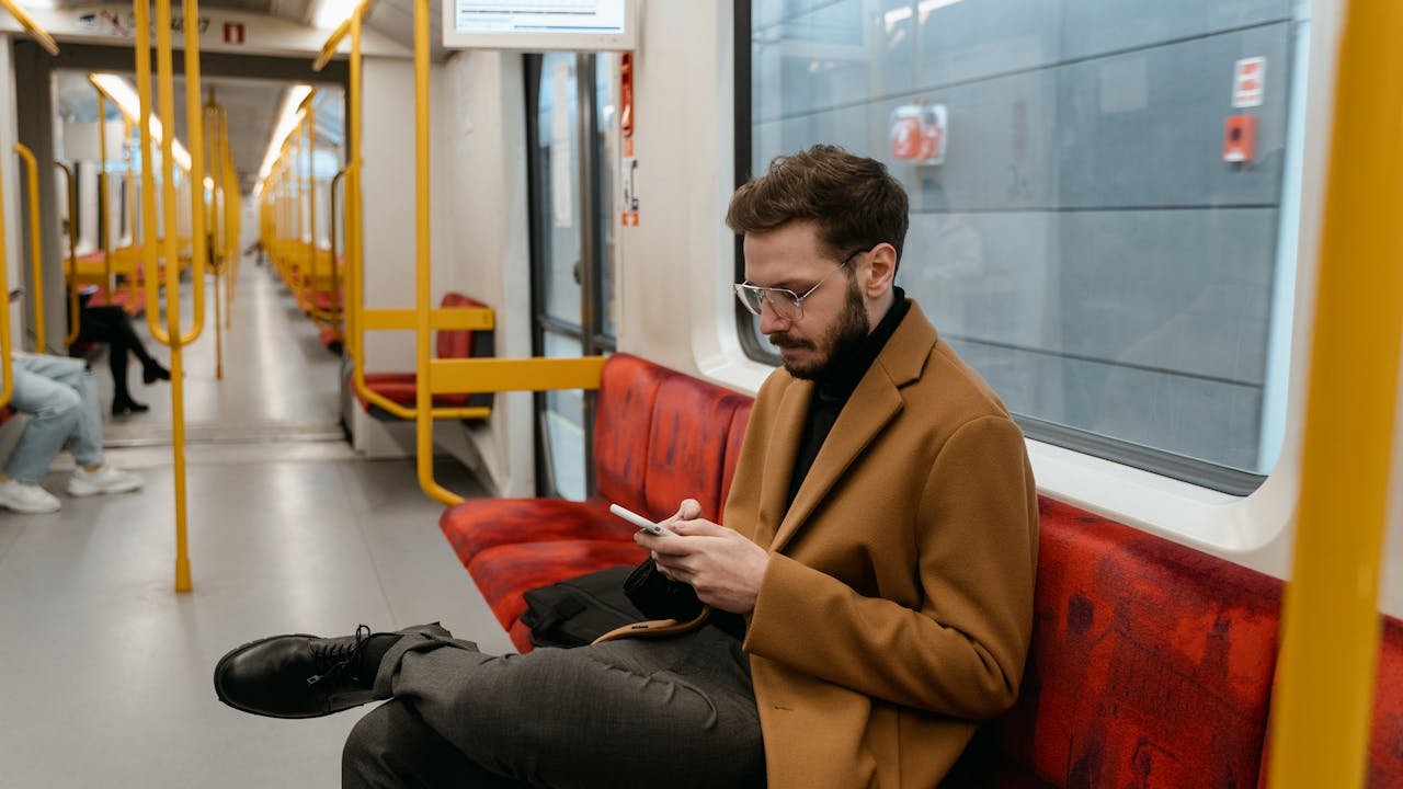 A man using his phone in a bus