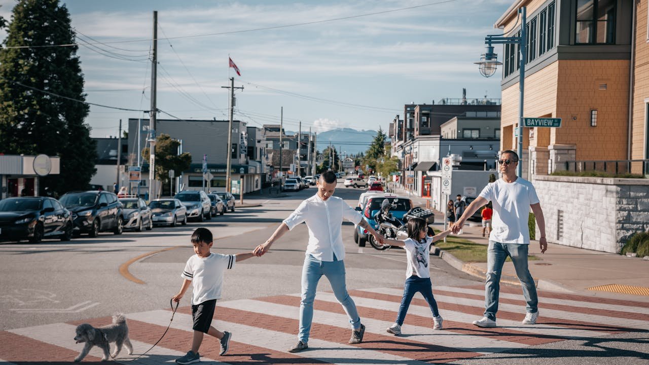 A family having fun while crossing the road